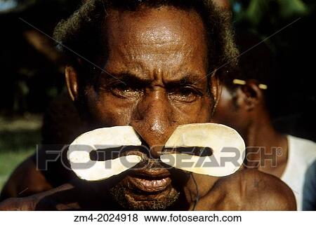 Stock Photo - WEST NEW GUINEA, (IRIAN JAYA, INDONESIA), ASMAT REGION, PRIMITIVE MAN WITH SHELL IN NOSE.. Fotosearch