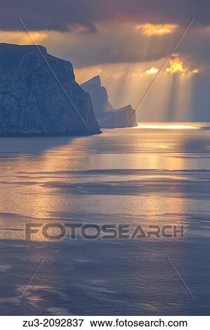Stock Photo - Western coast of Majorca, Estellencs area. Dragonera isle silhouette [center] at sunset. Balearic islands, Spain. Fotosearch