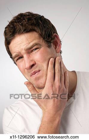 Stock Photograph - white caucasian male man suffering toothache. Fotosearch