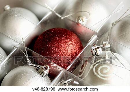 White Christmas balls and a red Christmas ball A box of eight satin white Christmas balls with a crimson ball in the center The red ball has a glitter surface View Large Photo Image Stock Photo - White Christmas balls and a red Christmas ball A box of eight satin white Christmas balls with a crimson ball in the center The red ball has a glitter surface. Fotosearch