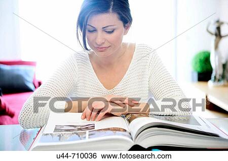 White dressed 40s woman working over the table View Large Photo Image Stock Photograph - White dressed 40s woman working over the table. Fotosearch
