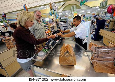 White female at check out in grocery store View Large Photo Image Stock Image - White female at check out in grocery store. Fotosearch