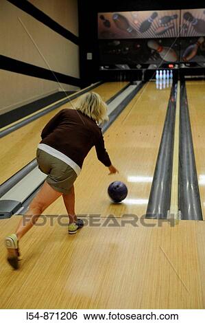 White female bowling and throwing ball down lane aiiming at pins View Large Photo Image Stock Photograph - White female bowling and throwing ball down lane aiiming at pins. Fotosearch