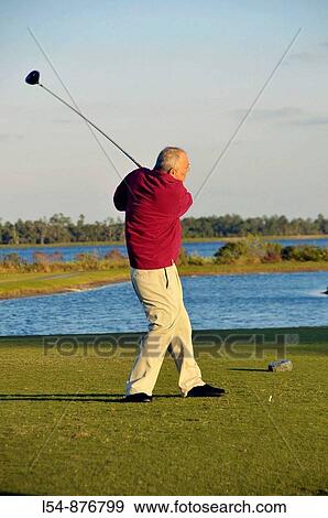 White Male Senior Citizen swings golf club on Florida golf course in retirement community View Large Photo Image Stock Photo - White Male Senior Citizen swings golf club on Florida golf course in retirement community. Fotosearch