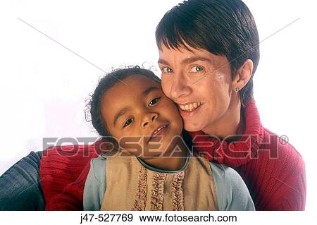 white Mother and black 4 year old daughter, sitting together smiling into camera View Large Photo Image Stock Photo - white Mother and black 4 year old daughter, sitting together smiling into camera. Fotosearch