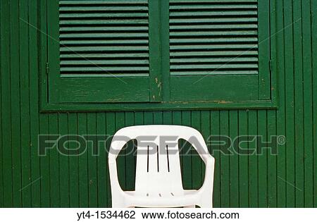 White Plastic Chair in front of Green Hut View Large Photo Image Stock Image - White Plastic Chair in front of Green Hut. Fotosearch