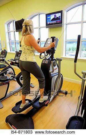 White woman on stair stepper machine in fitness center View Large Photo Image Stock Image - White woman on stair stepper machine in fitness center. Fotosearch