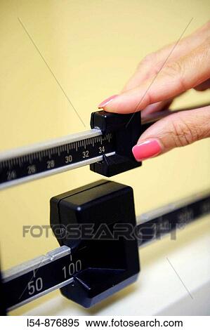 White woman uses balance scale to measure weight View Large Photo Image Stock Photography - White woman uses balance scale to measure weight. Fotosearch