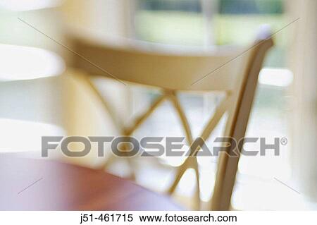 White wooden chair at wooden table, window behind in eating area, abstract view with selective focus and blur. View Large Photo Image Stock Photography - White wooden chair at wooden table, window behind in eating area, abstract view with selective focus and blur.. Fotosearch
