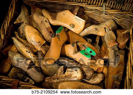 Wicker basket filled with lots of wooden shoe lasts in London, England, UK, Europe View Large Photo Image Picture - Wicker basket filled with lots of wooden shoe lasts in London, England, UK, Europe. Fotosearch