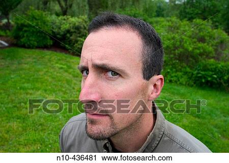 Stock Image - Wide angle close-up of a young man at a park.. Fotosearch