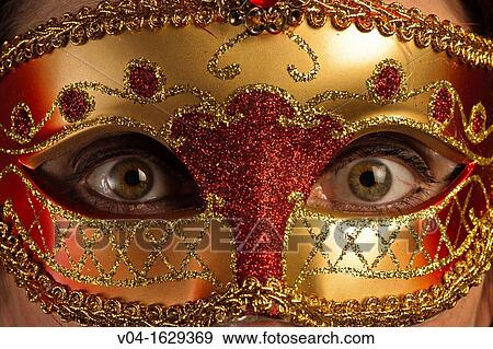 Wide opened eyes of a woman behind a venetian mask View Large Photo Image Stock Photo - Wide opened eyes of a woman behind a venetian mask. Fotosearch