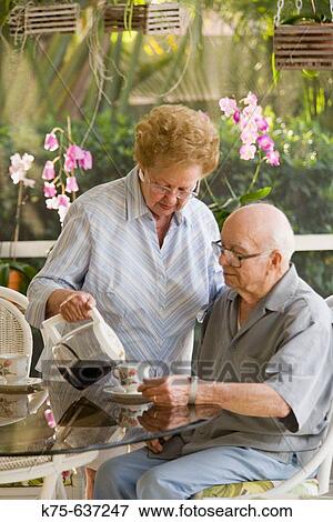 Wife pouring coffee for her husband View Large Photo Image Stock Photo - Wife pouring coffee for her husband. Fotosearch
