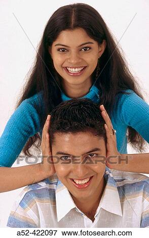 Wife preventing husband from hearing. View Large Photo Image Stock Photo - Wife preventing husband from hearing.. Fotosearch