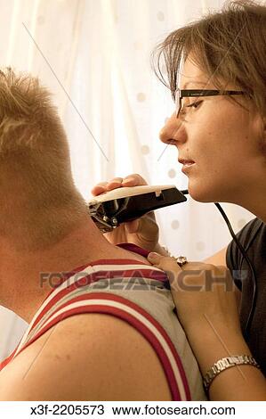 Wife trimming hair on back of neck of her husband with electric trimmer age 35 and 30. St Paul Minnesota MN USA. View Large Photo Image Stock Image - Wife trimming hair on back of neck of her husband with electric trimmer age 35 and 30. St Paul Minnesota MN USA.. Fotosearch