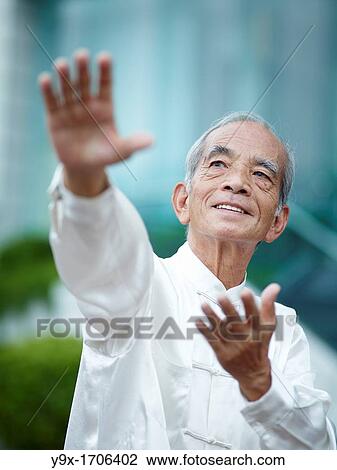 William Ng, a Tai Chi master practicing Tai Chi on the deck of The Peninsula Hotel, overlooking Hong Kong Victoria Harbour skyline View Large Photo Image Stock Image - William Ng, a Tai Chi master practicing Tai Chi on the deck of The Peninsula Hotel, overlooking Hong Kong Victoria Harbour skyline. Fotosearch
