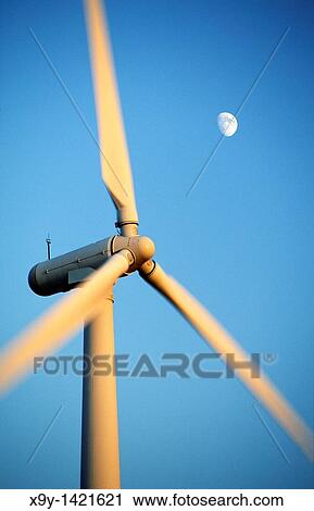 Wind turbine rotors with blue sky and moon generating electricity on wind farm at Bryn Titli near Rhayader, central Wales, UK View Large Photo Image Stock Image - Wind turbine rotors with blue sky and moon generating electricity on wind farm at Bryn Titli near Rhayader, central Wales, UK. Fotosearch