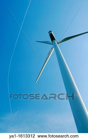 Wind turbine with a smoke trace of airliner jet plane on blue sky, Lorraine region - France View Large Photo Image Stock Image - Wind turbine with a smoke trace of airliner jet plane on blue sky, Lorraine region - France. Fotosearch