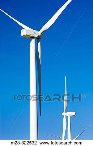 Wind turbines stand amidst the plains of eastern Montana near the Rocky Mountain front ranges of Glacier National Park USA View Large Photo Image Stock Image - Wind turbines stand amidst the plains of eastern Montana near the Rocky Mountain front ranges of Glacier National Park USA. Fotosearch