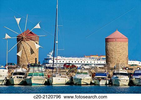 Windmills and tourists boats, in Mandraki harbor, Rhodes town, Rhodes island, Greece. View Large Photo Image Stock Photograph - Windmills and tourists boats, in Mandraki harbor, Rhodes town, Rhodes island, Greece.. Fotosearch
