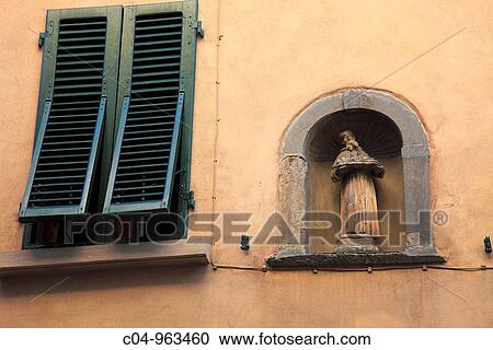 Stock Image - Window and statue, Volterra. Tuscany, Italy. Fotosearch