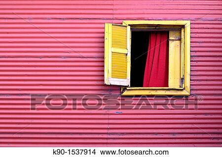 Picture - Window to the world: Red house of tin plates with one open, yellow window in El Caminito, La Boca, Buenos Aires, Argentina, South America. Fotosearch