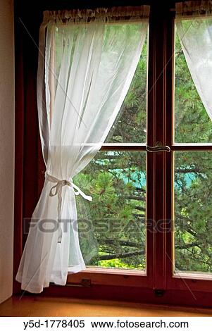 Window with curtain in a residential building seen from interior, symbol of privacy at home View Large Photo Image Stock Photography - Window with curtain in a residential building seen from interior, symbol of privacy at home. Fotosearch