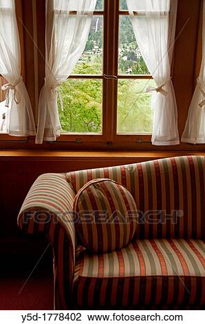 Windows with curtains in a residential building next to couch, interior, symbol of privacy at home View Large Photo Image Stock Image - Windows with curtains in a residential building next to couch, interior, symbol of privacy at home. Fotosearch