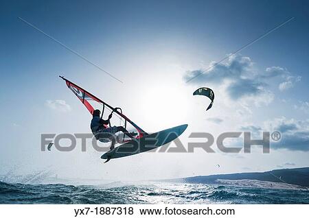 Stock Photo - Windsurfer jumping. Tarifa, Costa de la Luz, Cadiz, Andalusia, Spain, Europe.. Fotosearch