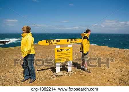 Windswept visitors at Slope Point - the southernmost point of New Zealand's South Island View Large Photo Image Picture - Windswept visitors at Slope Point - the southernmost point of New Zealand's South Island. Fotosearch