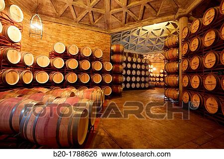 Stock Photograph - Wine cellar, Aging wine storage in barrels, Olarra winery, Rioja, Logroo, Spain. Fotosearch