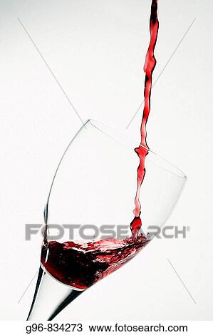 Stock Image - Wine pouring into a wineglass. Fotosearch