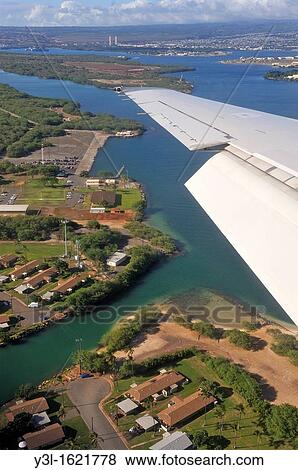 Wing of airplane arriving to Honolulu, Pearl harbor in the background, Oahu Island, Hawaii Islands, USA View Large Photo Image Stock Photo - Wing of airplane arriving to Honolulu, Pearl harbor in the background, Oahu Island, Hawaii Islands, USA. Fotosearch