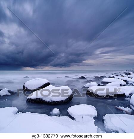 Stock Image - Winter storm over snow covered beach, Unstad, Lofoten islands, Norway. Fotosearch