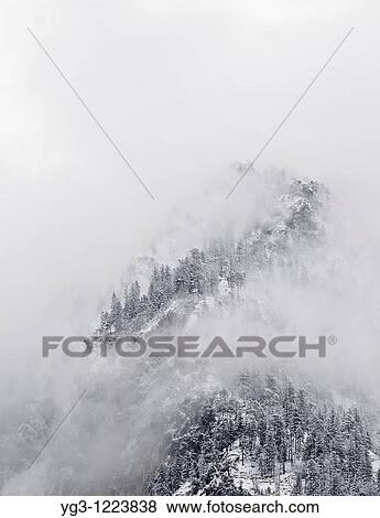Winter stormy clearing from snow covered hillside View Large Photo Image Stock Photo - Winter stormy clearing from snow covered hillside. Fotosearch