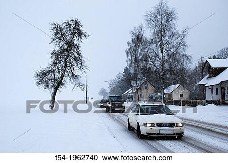 Stock Image - Wintry road conditions in a village in Bavaria. Fotosearch