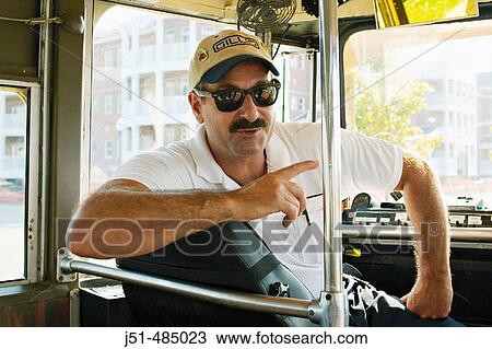 WISCONSIN. Kenosha. Restored streetcar, driver wearing baseball cap, turned around in seat, windshield View Large Photo Image Stock Image - WISCONSIN. Kenosha. Restored streetcar, driver wearing baseball cap, turned around in seat, windshield. Fotosearch