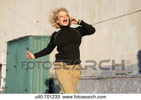 Stock Image - Woman 40's on cellphone. Fotosearch