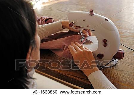 Woman 42 sewing with a machine, at home, France View Large Photo Image Stock Image - Woman 42 sewing with a machine, at home, France. Fotosearch