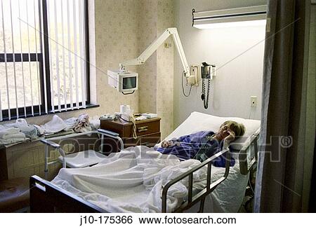 Stock Photograph - Woman age 84 in cardiac hospital ward. Poughkeepsie. New York. USA. Fotosearch