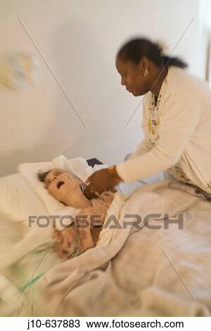Stock Image - Woman age 89, death hospice, with nurse, Poughkeepsie, NY. USA.. Fotosearch