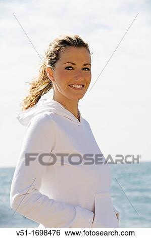 Stock Photograph - woman, air, beach, exercise, young adult. Fotosearch