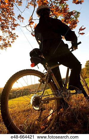 Woman alone outdoors on bicycle View Large Photo Image Stock Image - Woman alone outdoors on bicycle. Fotosearch