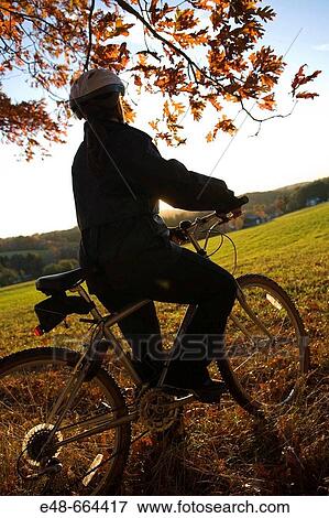 Woman alone outdoors on bicycle View Large Photo Image Stock Photo - Woman alone outdoors on bicycle. Fotosearch