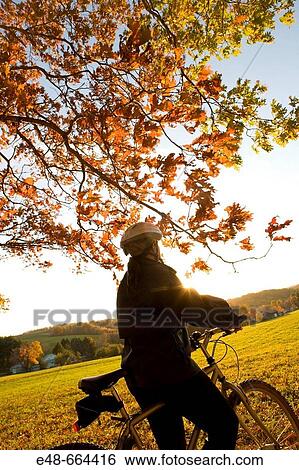 Woman alone outdoors on bicycle View Large Photo Image Stock Photograph - Woman alone outdoors on bicycle. Fotosearch