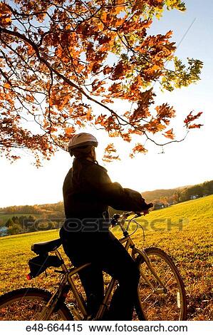 Woman alone outdoors on bicycle View Large Photo Image Stock Photography - Woman alone outdoors on bicycle. Fotosearch