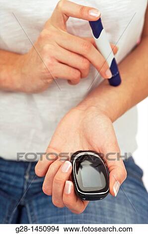 Picture - Woman and blood glucose test to treat diabetes. Fotosearch