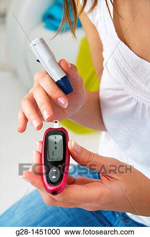 Stock Image - Woman and blood glucose test to treat diabetes. Fotosearch