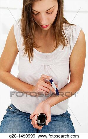Woman and blood glucose test to treat diabetes View Large Photo Image Stock Photo - Woman and blood glucose test to treat diabetes. Fotosearch