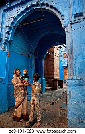 Woman and boy talking in front of a blue painted doorway Jodhpur, Rajasthan, India View Large Photo Image Stock Image - Woman and boy talking in front of a blue painted doorway Jodhpur, Rajasthan, India. Fotosearch